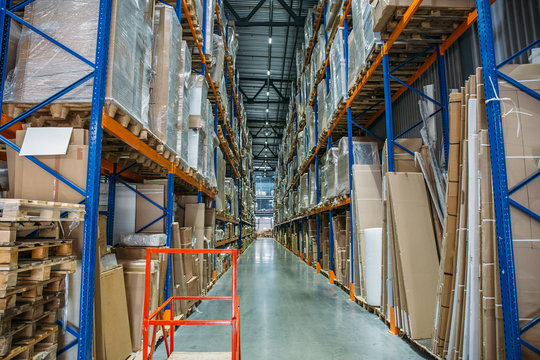 Logistics equipment, Large hangar warehouse with lots shelves or racks with pallets of goods. Industrial shipping and cargo delivery distribution