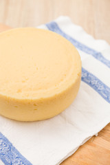 Closeup of a head of fresh organic cheese on a table. Food concept