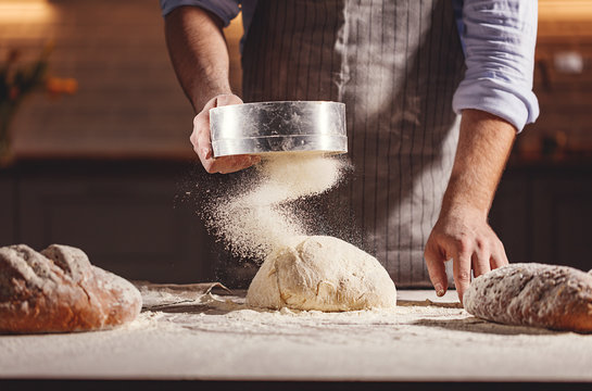Hands of baker kneading dough