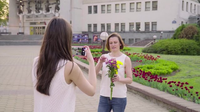 Beautiful woman having video using smartphone her daughter. Girl filming video photo her mom for social media with mobile phone
