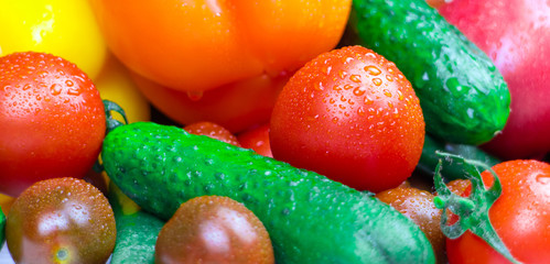 Fresh vegetables in the assortment close-up: cucumbers, tomatoes, pepper