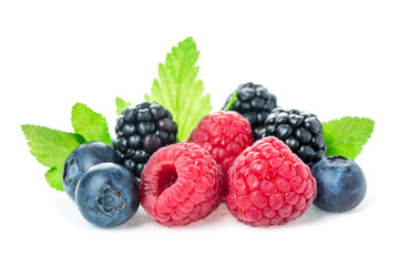 Healthy food berries mix. Macro shot of fresh raspberries, blueberries and blackberry with leaves isolated on white background.