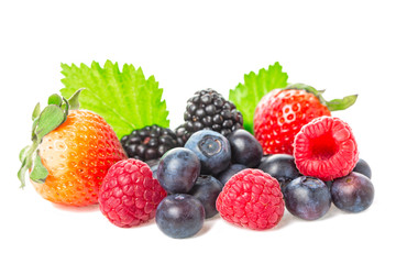 Healthy food berries group. Macro shot of fresh raspberries, blueberries, blackberries and strawberry with leaves isolated on white background.