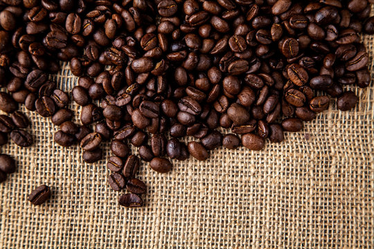 Dark roasted coffee beans with a hessian or jute natural colour sacking