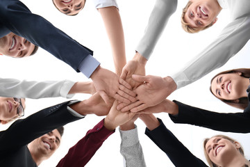 People putting hands together against white background. Unity concept