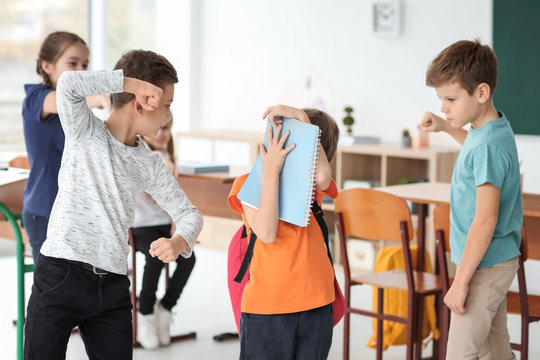 Children bullying their classmate in school