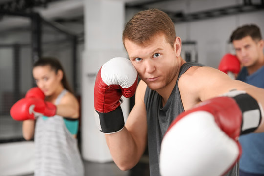 Young male boxer training in gym