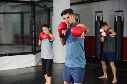 Young boxers warming up before training in gym