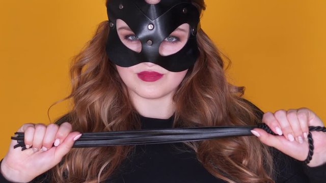 Tempting mistress playing with leather whip