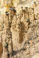 Natural phenomenon, peculiar rock formation - pile of earth pyramids with stone cap (andesite - volcanic rock), created by strong erosion of the soil.