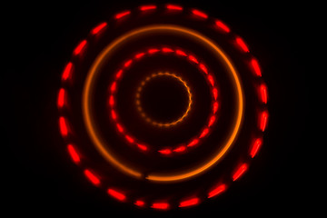 Music concept. Freezelight glowing vinyl on dark background or Turntable playing vinyl with glowing abstract lines concept on dark background.