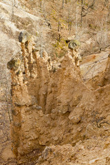 Natural phenomenon, peculiar rock formation - pile of earth pyramids with stone cap (andesite - volcanic rock), created by strong erosion of the soil.