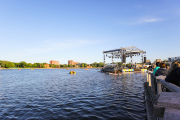 the crowd listens to a concert on a floating stage