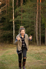 young girl at the autumn walk on the forest and fields 