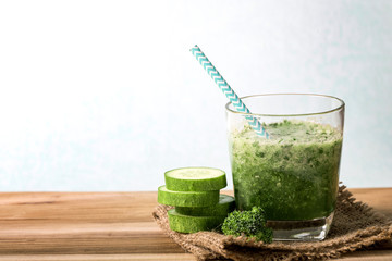 Detox green cucumber smoothie on a wooden table  , vegetable drink for health