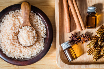 Close up brown organic Himalayan rock salt spa and cinnamon essential oil aroma set on  table , healthy spa relaxation concept