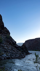 Fototapeta na wymiar Dawn at camp. Colorado River runs through Grand Canyon providing exciting whitewater rafting and incredible views along the way. Numerous side canyons can be hiked, often to beautiful waterfalls.
