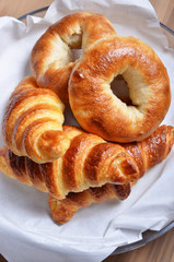 Closeup of a heap of bagels and croissants