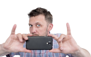 Bearded man photographed by smartphone, isolated on white background