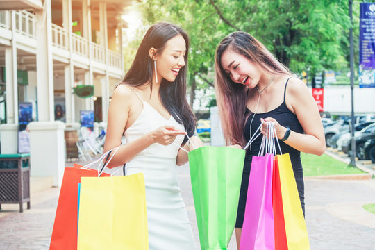 Happy Asian women friendship Enjoying Spending shopping bags in Fashion shopping street