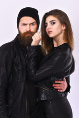 Girl and bearded man in black leather jacket and hat