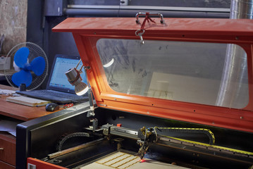Naklejka premium Closeup of dusty laser machine and operator's working place