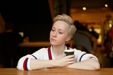 girl drinking coffee in a cafe