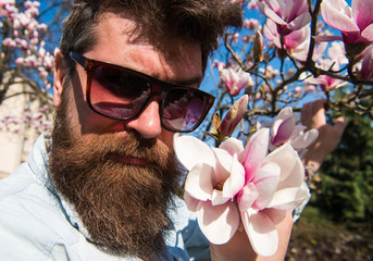 Guy looks cool with stylish sunglasses. Man with beard and mustache wears sunglasses on sunny day,...
