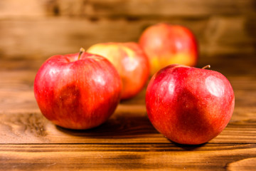 Ripe red apples on the wooden table
