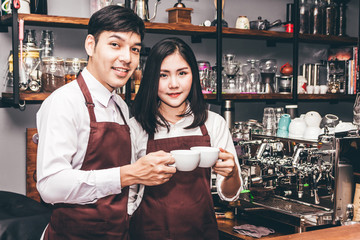 Barista giving coffee cup to customer at cafe