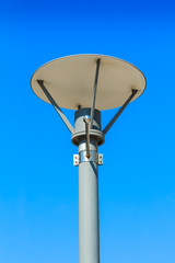 Isolated street light with sign pole on blue sky background