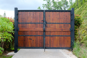 Wooden door swing on a large black steel frame that connects the house and the garden. Ideas for...