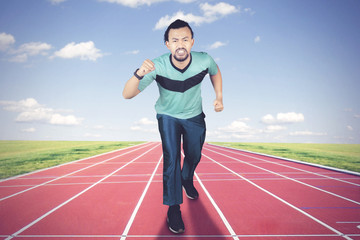 African man jogging on the running track