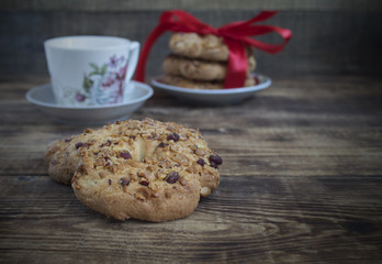 Chocolate chip cookie with peanuts nuts on wooden table. Homemade cake. The nut cookie.