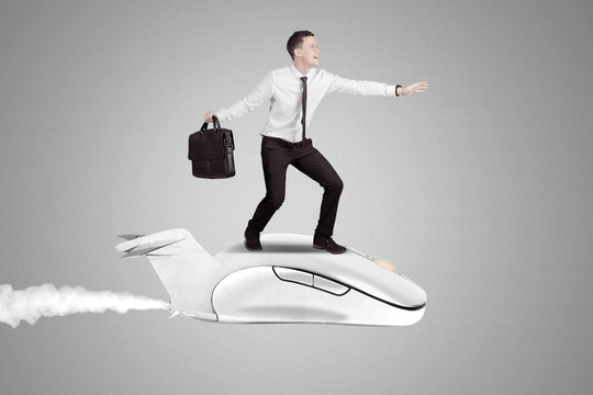 Businessman flying on a computer mouse