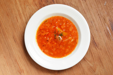 Tomato vegetable soup on wooden table           