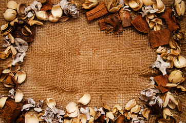 texture background of fabric with frame of dry flowers 