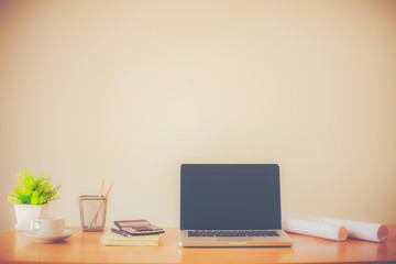 Laptop with blank screen on table.