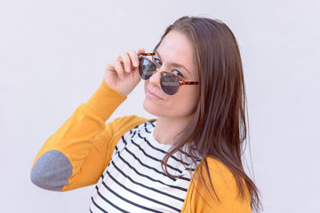 Woman looking over sunglasses