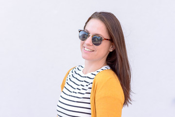 Happy young brunette woman with sunglasses