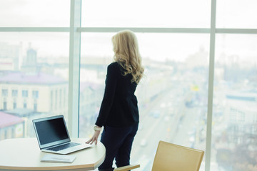 woman blonde worker office big window view city