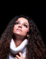 beautiful women with long hair in a sweater looking up.