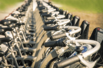 Fototapeta premium Close up of rental bicycles on rental station on the street
