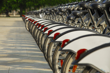 Fototapeta premium Close up of rental bicycles on rental station on the street
