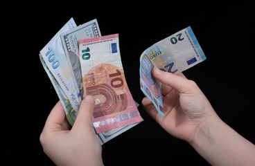 Hand holding American dollar  isolated on black background