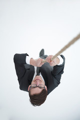 successful businessman climbing the rope