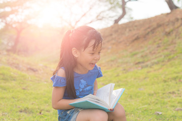 Little girl reading a book