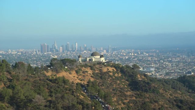 Griffith Observatory building and downtown Los Angeles cityscape at sunset - August 2017: Los Angeles California, US