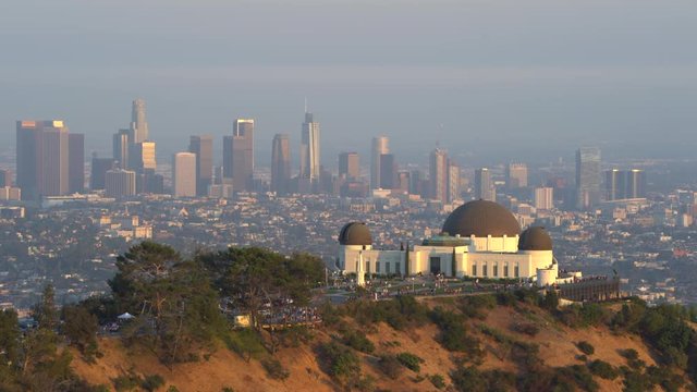Griffith Observatory building and downtown Los Angeles cityscape at sunset - August 2017: Los Angeles California, US