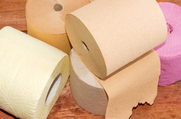 Rolls of various toilet paper different colors closeup